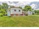 Charming two-story home with brick and vinyl siding, a well-manicured lawn, and mature trees at 3624 Woodcliff Dr, Indianapolis, IN 46203