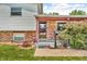 Inviting front porch with brick accents, blossoming shrubbery, and a pathway leading to the front door at 3624 Woodcliff Dr, Indianapolis, IN 46203
