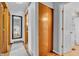 Hallway with a mirror and multiple doors leading to various rooms at 3624 Woodcliff Dr, Indianapolis, IN 46203