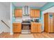 Well-equipped kitchen with stainless steel range, light wood cabinets, and modern backsplash at 3624 Woodcliff Dr, Indianapolis, IN 46203