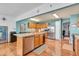 Spacious kitchen with stainless steel appliances, an island with a double sink, and wooden cabinets at 3624 Woodcliff Dr, Indianapolis, IN 46203
