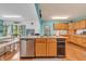Open kitchen with stainless steel appliances, island with sink, and adjacent dining area at 3624 Woodcliff Dr, Indianapolis, IN 46203