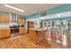 Open-concept kitchen featuring an island, stainless steel appliances, and a dining area at 3624 Woodcliff Dr, Indianapolis, IN 46203