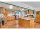 Bright kitchen featuring a center island, stainless steel appliances, and warm oak cabinets at 3624 Woodcliff Dr, Indianapolis, IN 46203