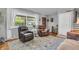 Bright living room featuring hardwood floors, neutral walls, and two recliners by the large window at 3624 Woodcliff Dr, Indianapolis, IN 46203
