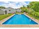 Fenced in ground pool with ladders surrounded by patio, backyard and storage shed at 3624 Woodcliff Dr, Indianapolis, IN 46203