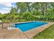 In-ground swimming pool surrounded by lush greenery with a shed for storage and pool equipment at 3624 Woodcliff Dr, Indianapolis, IN 46203