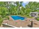 In-ground swimming pool with surrounding patio and mature trees for a secluded outdoor experience at 3624 Woodcliff Dr, Indianapolis, IN 46203