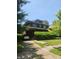 Charming two-story brick home with lush landscaping and a private driveway, offering classic curb appeal at 3702 N Delaware St, Indianapolis, IN 46205