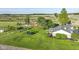 Aerial view of a home with a trampoline, play set, red barn, and an expansive, well-manicured lawn at 3840 W 38Th St, Anderson, IN 46011