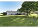 Expansive backyard with lush lawn and mature tree providing ample space for outdoor activities at 3840 W 38Th St, Anderson, IN 46011