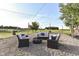 The backyard patio features wicker furniture and a firepit perfect for gathering and outdoor enjoyment at 3840 W 38Th St, Anderson, IN 46011