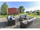 Outdoor patio featuring wicker furniture, a cozy fire pit, and string lights, ideal for relaxing evenings at 3840 W 38Th St, Anderson, IN 46011