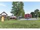 Picturesque backyard featuring a playground, barn, and lush greenery, creating an ideal outdoor living space at 3840 W 38Th St, Anderson, IN 46011