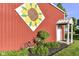 Close-up of barn with decorative sunflower painting, bicycle, and landscaping at 3840 W 38Th St, Anderson, IN 46011