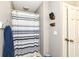 Cozy bathroom with blue and white striped shower curtain at 3840 W 38Th St, Anderson, IN 46011