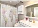 Bright bathroom featuring a map-themed shower curtain, white vanity, and ample storage space at 3840 W 38Th St, Anderson, IN 46011