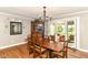 Inviting dining area with hardwood floors, a wooden table, and glass doors leading to the sunroom at 3840 W 38Th St, Anderson, IN 46011