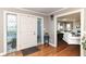 Inviting foyer with leaded glass sidelights, hardwood floors, and a white front door provides a warm welcome at 3840 W 38Th St, Anderson, IN 46011