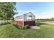 Exterior of a charming greenhouse with a red base, perfect for gardening enthusiasts and plant cultivation at 3840 W 38Th St, Anderson, IN 46011