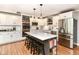 Open kitchen with white cabinets, a center island, and stainless steel appliances offers a chef's dream at 3840 W 38Th St, Anderson, IN 46011