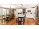Bright kitchen featuring white cabinetry, an island, stainless steel appliances, and a dining area at 3840 W 38Th St, Anderson, IN 46011