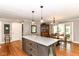 Stylish kitchen island with granite countertop, pendant lighting, and seating is perfect for casual dining at 3840 W 38Th St, Anderson, IN 46011