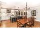 Open kitchen and dining area featuring an island, white cabinets, and wood dining table at 3840 W 38Th St, Anderson, IN 46011