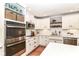 Bright kitchen boasts white cabinets, stainless steel appliances, and granite counters for a modern feel at 3840 W 38Th St, Anderson, IN 46011