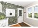 Charming laundry room with elegant wallpaper, functional appliances, and convenient outdoor access at 3840 W 38Th St, Anderson, IN 46011
