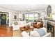 Cozy living room boasts a fireplace, window seat, and white furniture for a comfortable gathering space at 3840 W 38Th St, Anderson, IN 46011