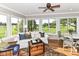 Bright sunroom with a ceiling fan, large windows offering serene outdoor views and stylish decor at 3840 W 38Th St, Anderson, IN 46011