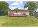 Backyard view with a wooden deck attached to the home and a green lawn at 3898 S Randolph St, Indianapolis, IN 46227