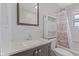 Bathroom with a dark vanity and granite countertops has shower and storage shelves at 3898 S Randolph St, Indianapolis, IN 46227