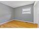 Cozy bedroom with hardwood floors, neutral gray paint, and a window offering ample natural light at 3898 S Randolph St, Indianapolis, IN 46227