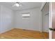 Bedroom with light walls and laminate floor features a ceiling fan and closet at 3898 S Randolph St, Indianapolis, IN 46227