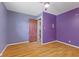 Bedroom with laminate floors and closet features a door leading to another room at 3898 S Randolph St, Indianapolis, IN 46227
