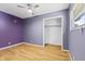 Bedroom with wood-look floors features a ceiling fan and closet with shelf at 3898 S Randolph St, Indianapolis, IN 46227