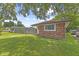 Exterior side view of a brick home with large picture window and green lawn at 3898 S Randolph St, Indianapolis, IN 46227