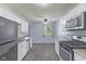 Updated kitchen with stainless steel appliances, granite countertops, and white cabinetry at 3898 S Randolph St, Indianapolis, IN 46227