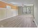 Bright living room with large windows, gray wood floors, and neutral paint colors offering a modern touch at 3898 S Randolph St, Indianapolis, IN 46227