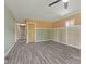 Spacious living room featuring modern gray wood flooring, and neutral paint colors with classic wainscoting at 3898 S Randolph St, Indianapolis, IN 46227