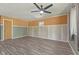 A spacious living room features updated flooring, neutral color scheme, and a modern ceiling fan at 3898 S Randolph St, Indianapolis, IN 46227