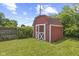 Exterior shot of a red shed in the backyard with double doors and green lawn at 3898 S Randolph St, Indianapolis, IN 46227