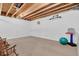 Unfinished basement offering ample space with exposed ceiling, carpeted floor and recreational equipment at 4157 Taunton Ct, Plainfield, IN 46168