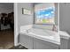 Bathroom featuring a large soaking tub with window view, plus open walk-in closet at 4157 Taunton Ct, Plainfield, IN 46168