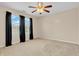 Bedroom showcasing neutral walls, ceiling fan and windows dressed with black curtains at 4157 Taunton Ct, Plainfield, IN 46168