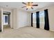 Bedroom with ceiling fan, large closet, and windows dressed with black curtains at 4157 Taunton Ct, Plainfield, IN 46168