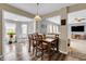 Inviting dining area with wood table, chairs, and seamless flow into the living spaces with modern flooring at 4157 Taunton Ct, Plainfield, IN 46168