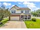 Inviting two-story home boasts blue shutters, brick accents, manicured lawn, and a welcoming front porch at 4157 Taunton Ct, Plainfield, IN 46168